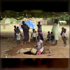 Nuba woman and children diging 